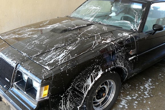 Vintage car getting washed with soapy suds