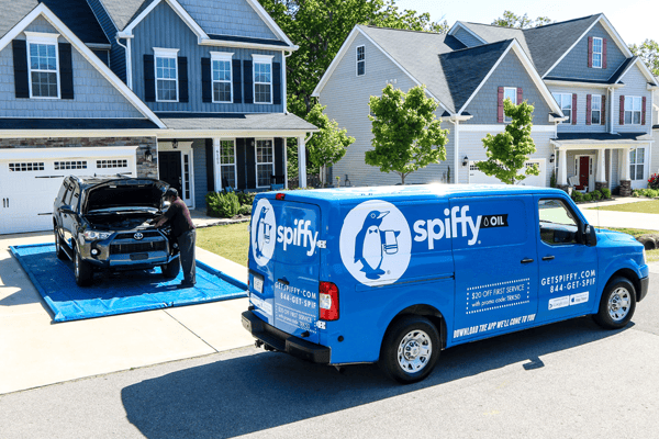 Spiffy Oil van and tech perform a mobile oil change service