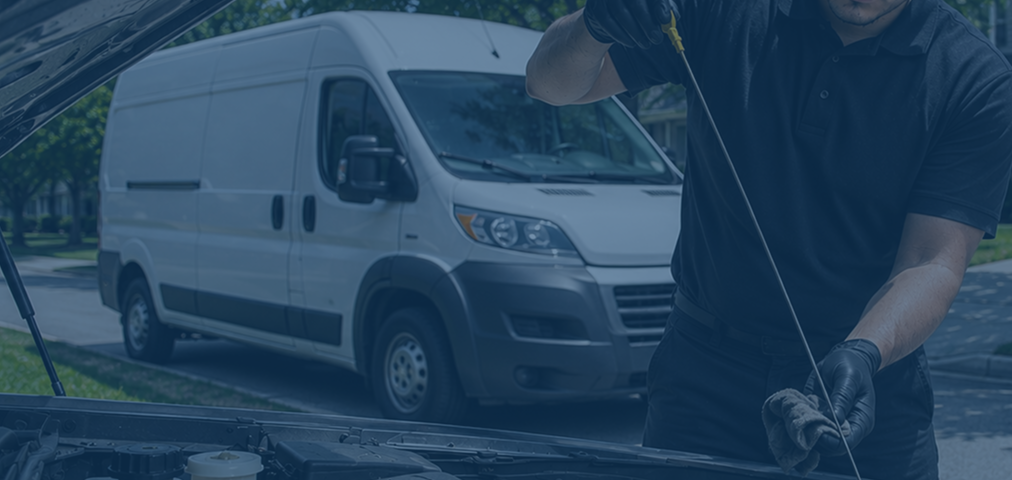 Spiffy technician inspecting the engine of a fleet van under the hood
